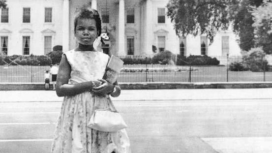 Condoleeza Rice stands in front of the White House as a girl.